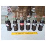Six Unopened Coke Bottles