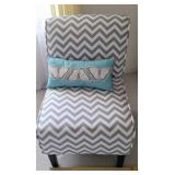 Gray and white chevron accent chair with pillow