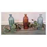 Table center piece with glass bottles and metal