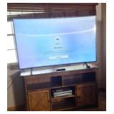 Curved Samsung 65" TV with wooden cabinet, vcr