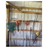 Contents on wall including blowers, pitch fork,