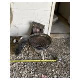 Charcoal grill with half full bag of charcoal.