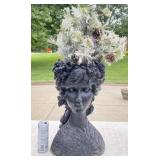 Black resin woman planter with Christmas tree