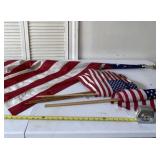 Hand held flags and flag on pole with eagle tip