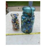 Ball jar of marbles and 3 cent jar full