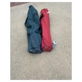 Two folding arm chairs in carrying bags