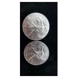 Two 2016 silver eagle coins.