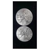 Two 2016 silver eagle dollars.