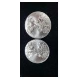 Two  2011 silver eagle dollars.