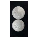 Two silver eagle dollars.