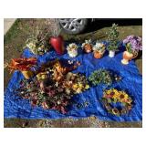 Artificial flower arrangements and decor on tarp,