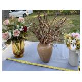 Glass vase with flower arrangement, has chip on