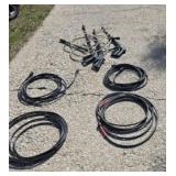 Pressure washer extra hoses and spray wands.