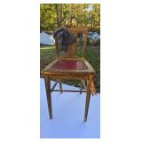 painted wooden chair with a red studded seat and
