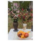 Flower vases with flower arrangements in them