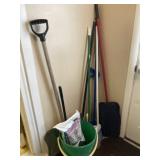 Bucket with ice melt, snow shovel, brooms and
