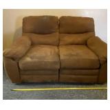 Brown love seat with recliners. It has stains.
