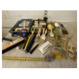 New paint brushes and pans with used supplies