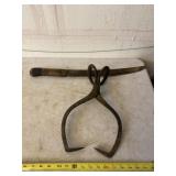 Cast iron ice block tongs and weed machete.