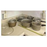 Hammered cast aluminum pans and lids.