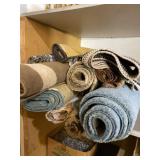 All rugs on shelf.