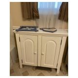 White cabinet measures 34 inches wide x 13 inches