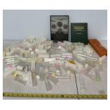 Coin tubes and empty coin quarter collector book.