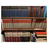 Three shelves of all bibles and holy books.