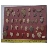 Indian artifacts glued to glass.