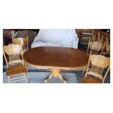 Large oak pedestal table with 4 press back