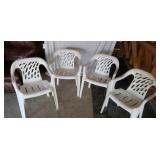 Four  plastic lawn chairs