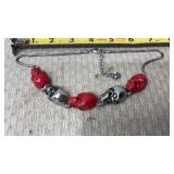 Gothic-style skull bracelet featuring red and