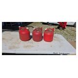 Three 1 1/4 gallon gas cans