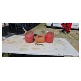 Three 1/4 gal gas cans