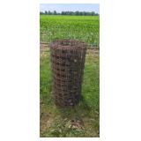 Roll of woven fence wire.