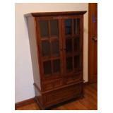 Brown Wood Display Cabinet Features Glass Doors