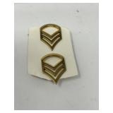 US Army Staff Sergeant (E-6) rank insignia pins.