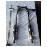 motorcycle swing arm with attached dual shocks and