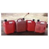 4 plastic gas cans one full of gas.