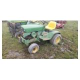Older John Deere riding lawn mower with front