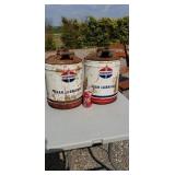 Two standard oil 5 gal cans.
