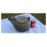Old cast iron wood stove kettle.