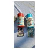 Two old  lunch pail thermoses.