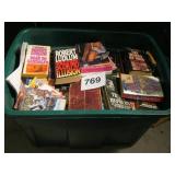 GREEN TOTE FULL OF PAPER BACK BOOKS