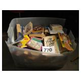 CLEAR TOTE FULL OF PAPER BACK BOOKS