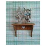 Painting, engraved picture, and a shelf with two