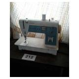 SINGER SEWING MACHINE W TABLE AND MISC SEWING