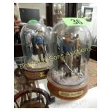 GROUP OF 3 GLASS INCASED JOHN WAYNE FIGURINES.