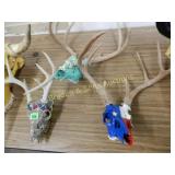GROUP OF 3 CUSTOM PAINTED DEER SKULLS