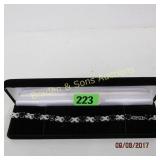 LADIES STERLING SILVER AND DARK BLUE SAPPHIRE